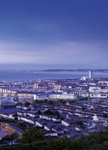 Aerial view showing Swansea at night by the sea
