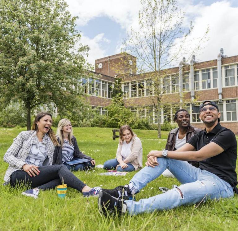 Students relaxing on grass
