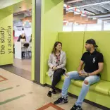 Student sitting on sofa outside the Study