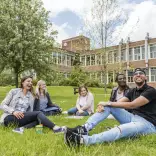 Students relaxing on grass
